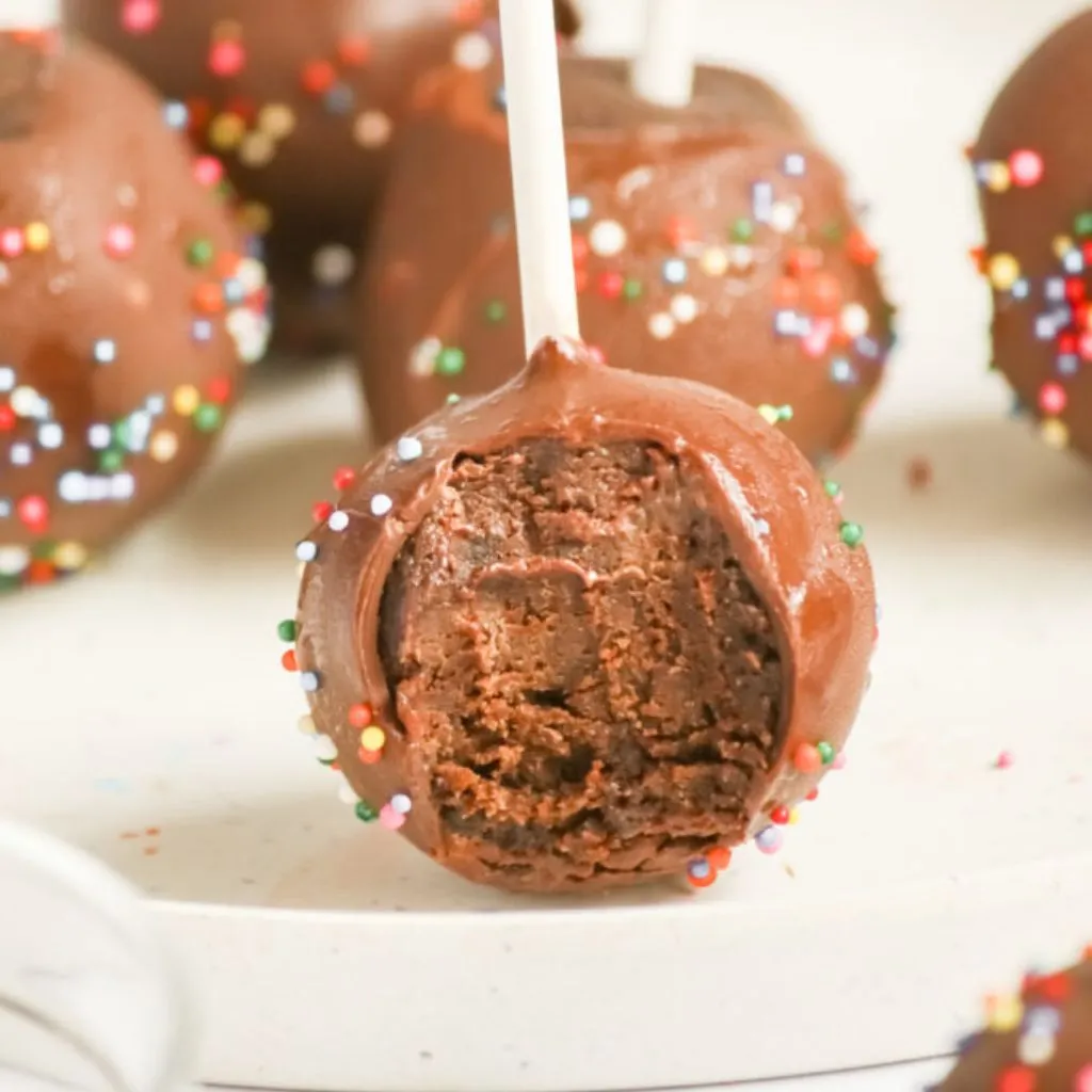 A warm and inviting image of people enjoying cake pops at a casual gathering, showcasing the joy and fun these treats bring to any occasion.